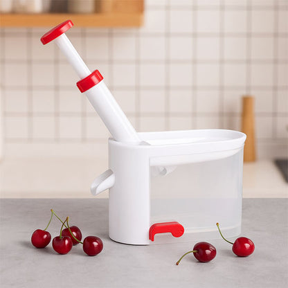 denoyauteur-cerise-sur-la-table-avec-des-cerises-autour